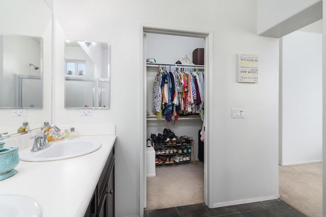 bathroom featuring vanity and a shower