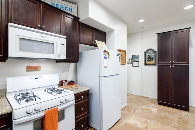 kitchen with light stone counters and white appliances