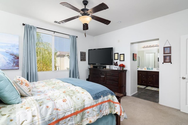 carpeted bedroom featuring ensuite bathroom and ceiling fan