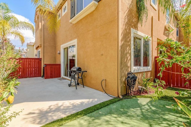 view of side of property with a patio area