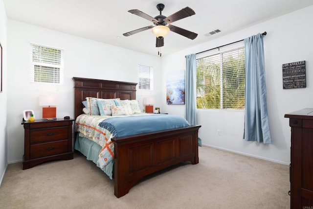 bedroom with ceiling fan and light colored carpet