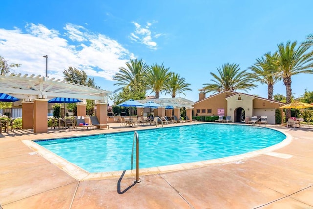 view of swimming pool with a pergola and a patio