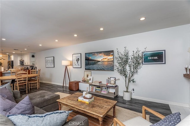 living room featuring baseboards, wood finished floors, and recessed lighting