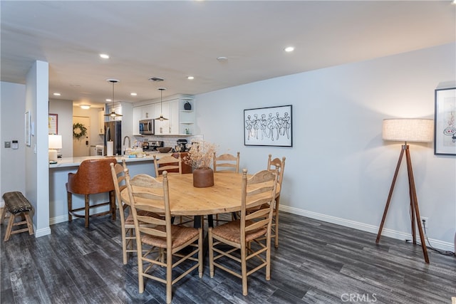 dining area featuring dark hardwood / wood-style floors and sink