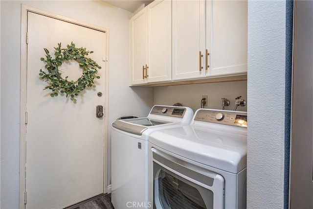 washroom featuring cabinet space and washing machine and dryer