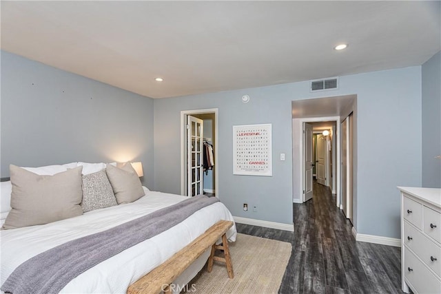 bedroom with recessed lighting, visible vents, baseboards, a spacious closet, and dark wood-style floors