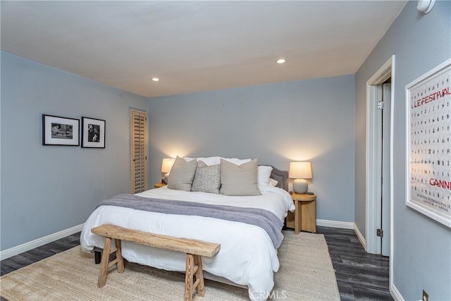 bedroom with recessed lighting, wood finished floors, and baseboards