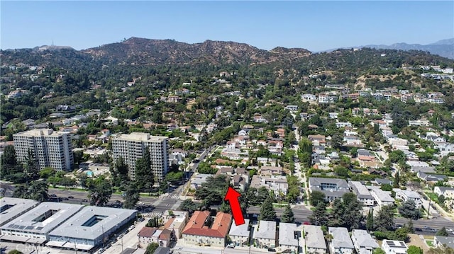 birds eye view of property with a mountain view