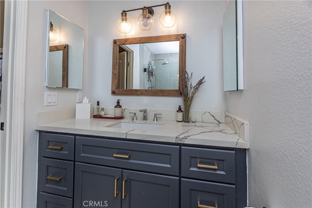 bathroom featuring a shower and vanity