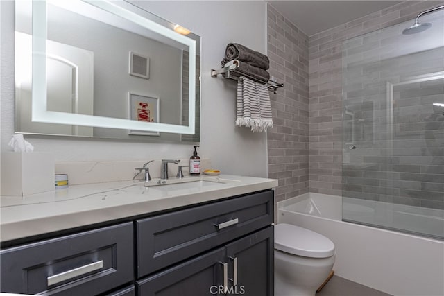 full bathroom featuring vanity, toilet, and tiled shower / bath