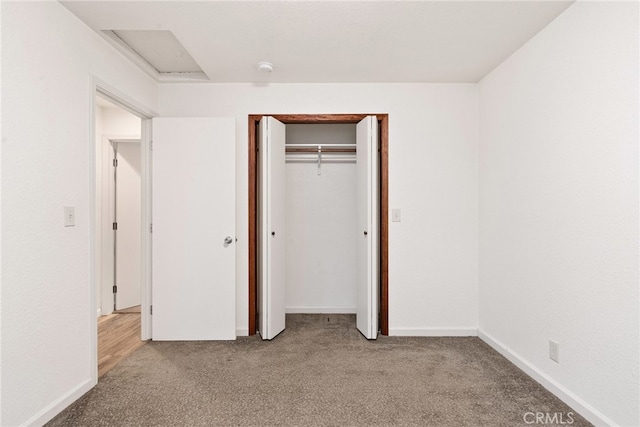 unfurnished bedroom with light carpet and a closet