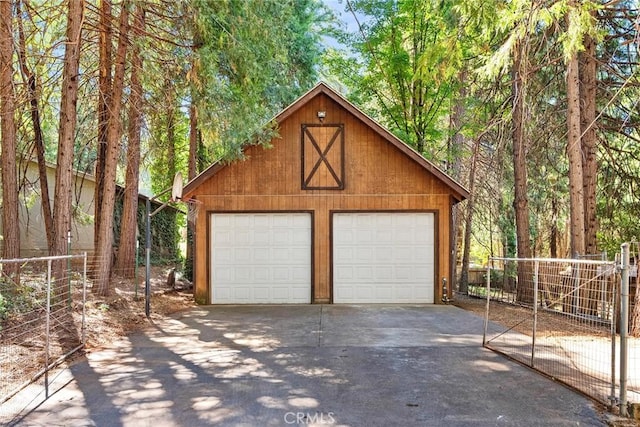 detached garage featuring fence