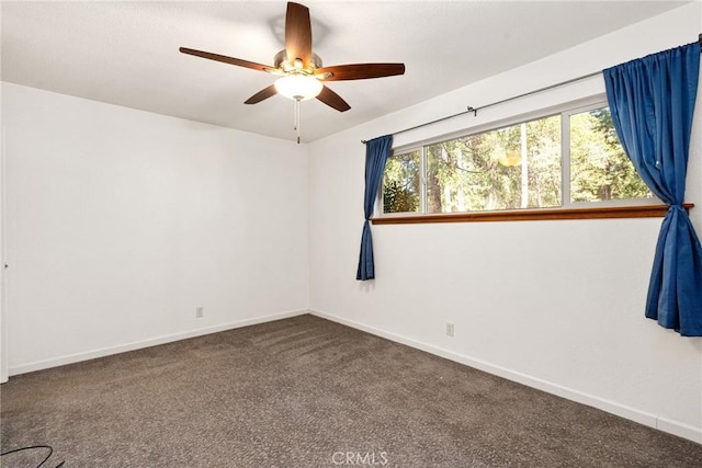 carpeted empty room with ceiling fan and baseboards
