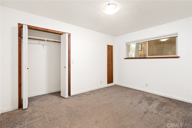 unfurnished bedroom featuring carpet floors and a closet