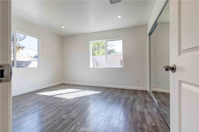 spare room featuring dark hardwood / wood-style flooring