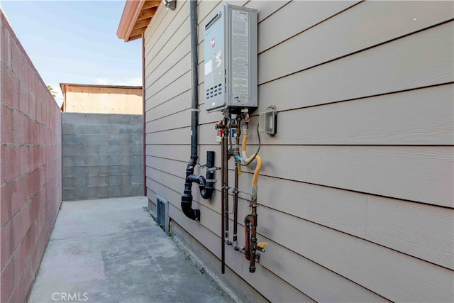 exterior details with water heater and concrete floors