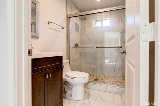 bathroom with a shower with shower door, vanity, and toilet