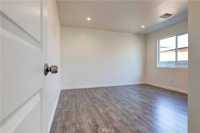 unfurnished room featuring wood-type flooring