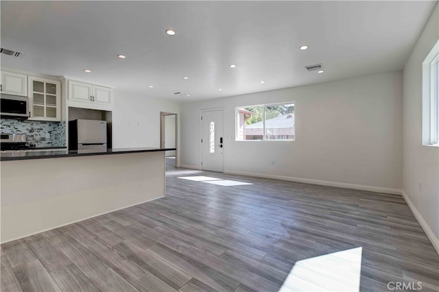 unfurnished living room with light hardwood / wood-style floors