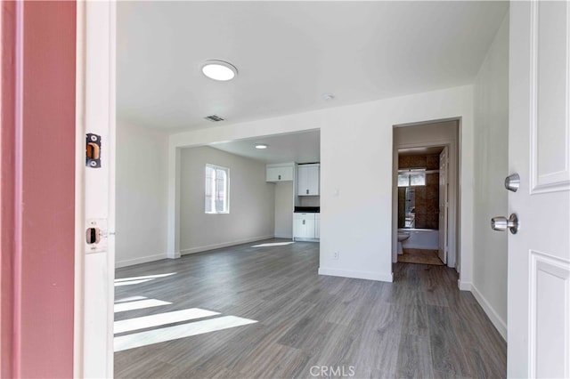 unfurnished living room featuring hardwood / wood-style flooring