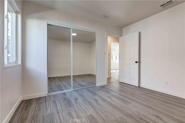 8812 Laurel Canyon Blvd, Sun Valley, CA 91352 - unfurnished bedroom featuring wood finished floors, baseboards, and a closet