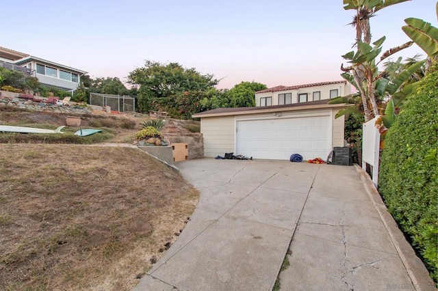 view of garage at dusk