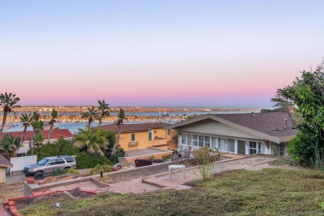 view of back house at dusk