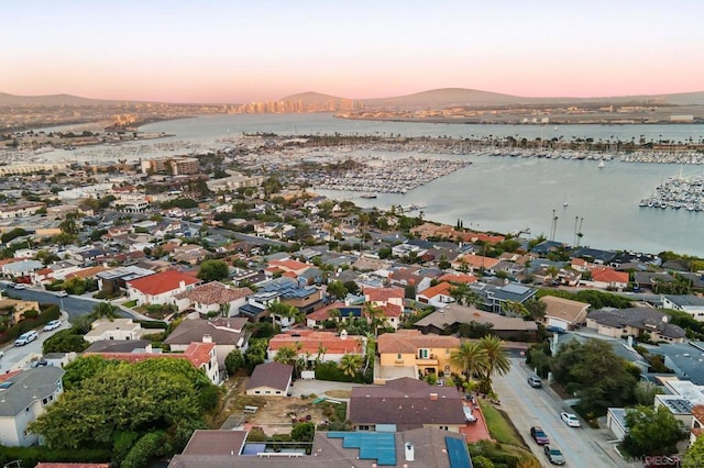 aerial view at dusk with a water and mountain view