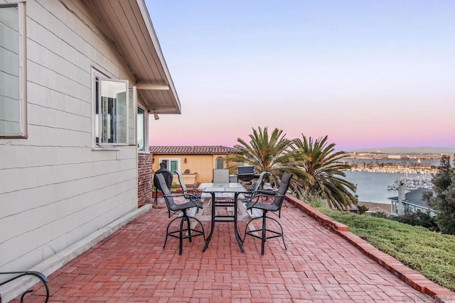 patio terrace at dusk with a water view