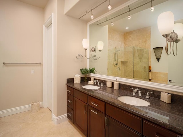 bathroom featuring an enclosed shower, vanity, tile patterned flooring, and track lighting