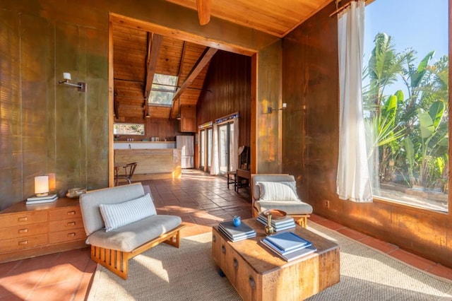 living area with light tile patterned floors, wood ceiling, and vaulted ceiling with skylight