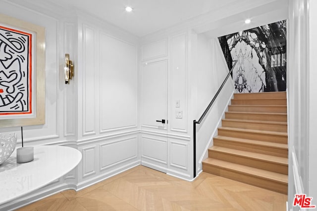 interior space with crown molding and parquet flooring