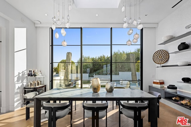 dining room featuring light parquet flooring and a wealth of natural light