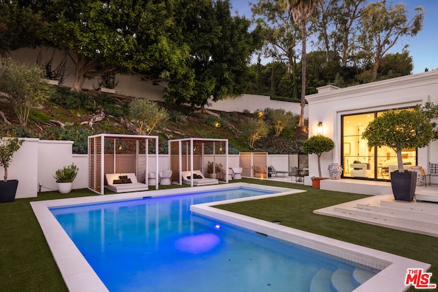 view of swimming pool featuring a lawn and a patio area