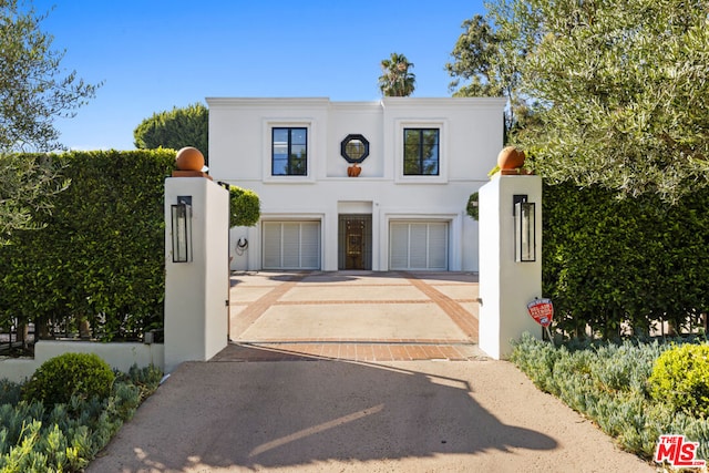 view of gate with a garage