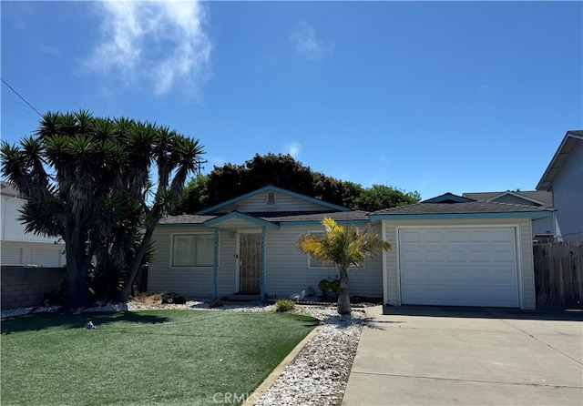 ranch-style house featuring a garage and a front lawn