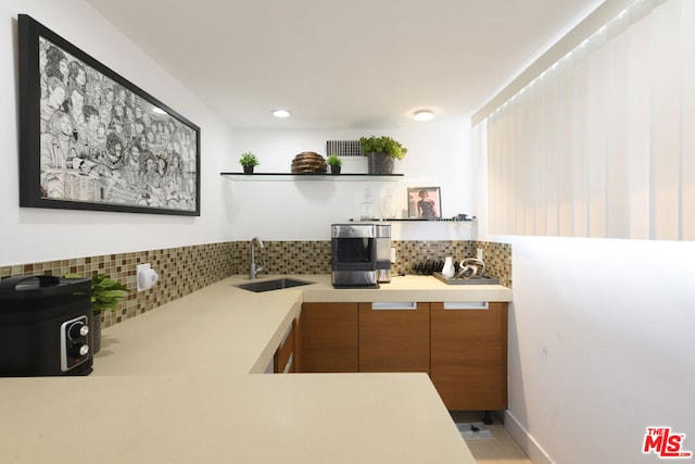 kitchen featuring sink and decorative backsplash