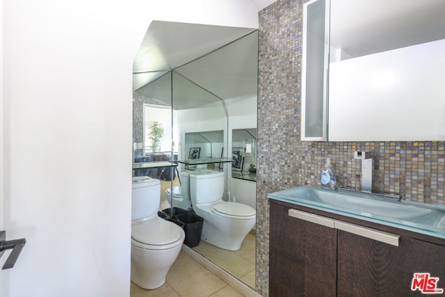 bathroom featuring decorative backsplash, tile patterned floors, vanity, and toilet