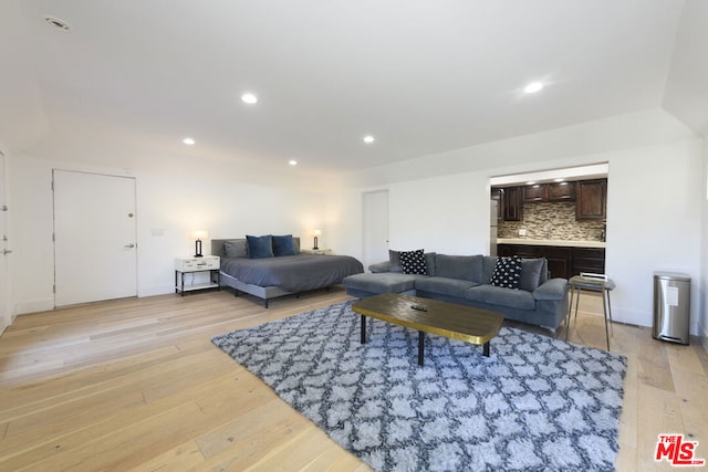 living room with light wood-type flooring and sink