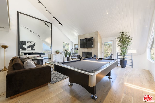 rec room with high vaulted ceiling, light hardwood / wood-style floors, a fireplace, and billiards