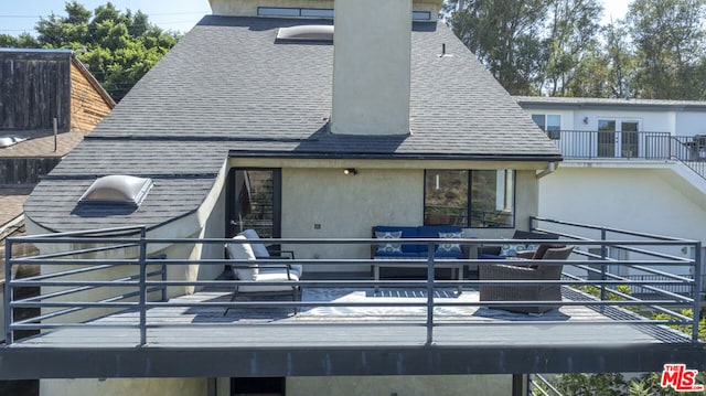 rear view of property featuring a balcony