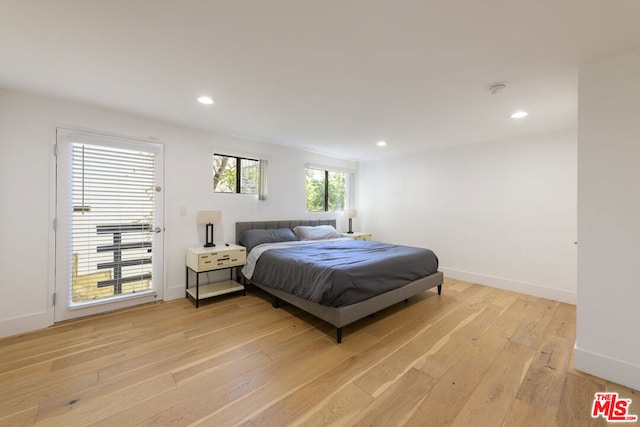 bedroom featuring access to outside and light hardwood / wood-style floors