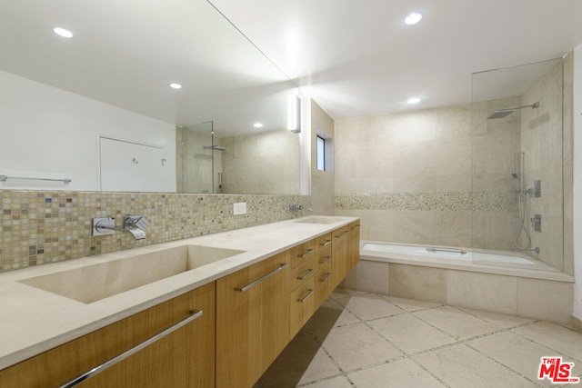 bathroom with vanity, decorative backsplash, and tile patterned floors