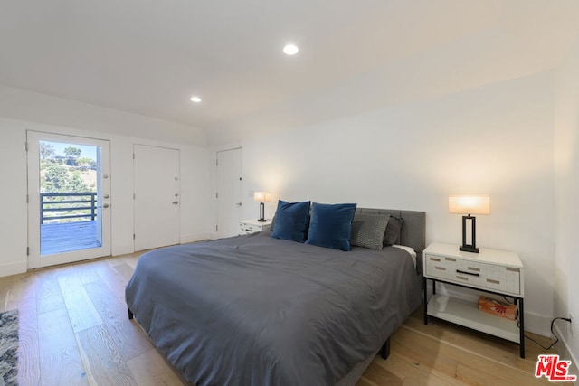 bedroom featuring light wood-type flooring and access to outside