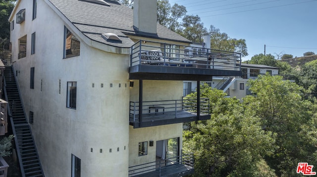 back of house with a balcony