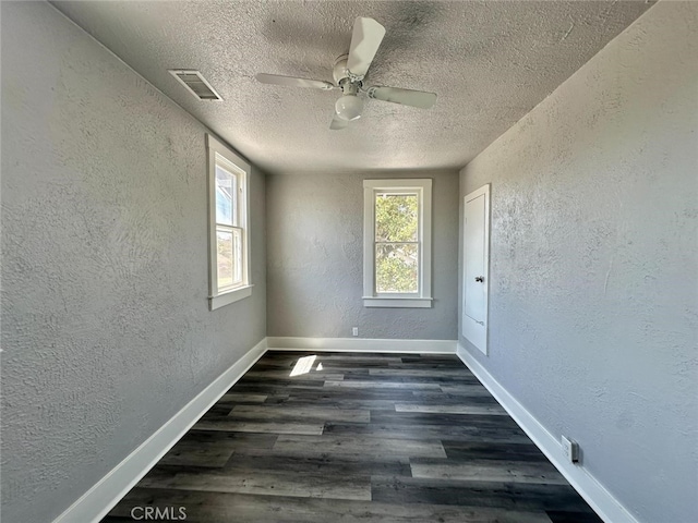 unfurnished room featuring a textured ceiling, dark hardwood / wood-style floors, and ceiling fan