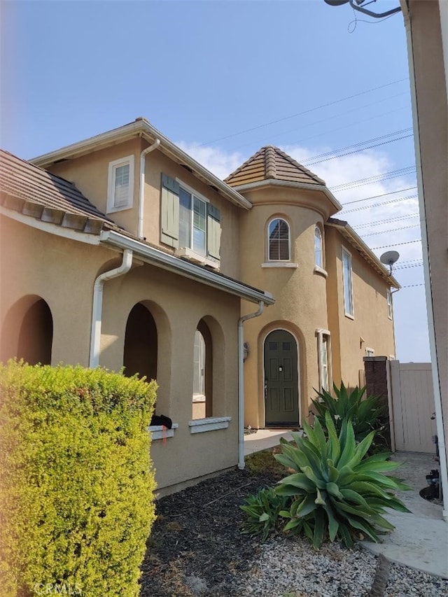 view of front of property featuring stucco siding and fence