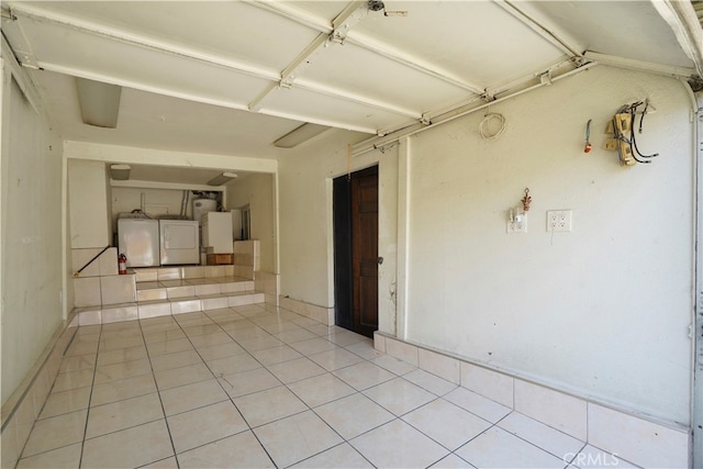 interior space featuring light tile patterned floors and washing machine and clothes dryer