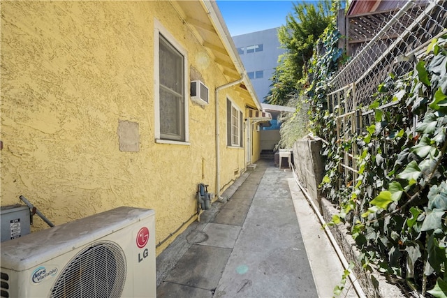 view of side of home featuring ac unit