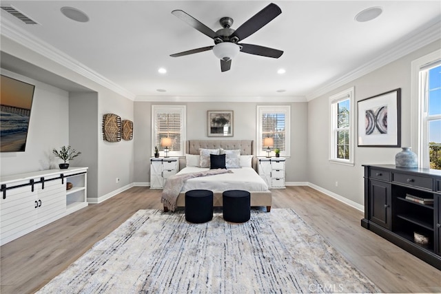 bedroom featuring ceiling fan, ornamental molding, and light wood-type flooring